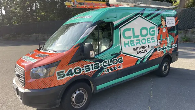 Wrapped Clog Heroes van in three-quarter front view showing the 540-518-CLOG number