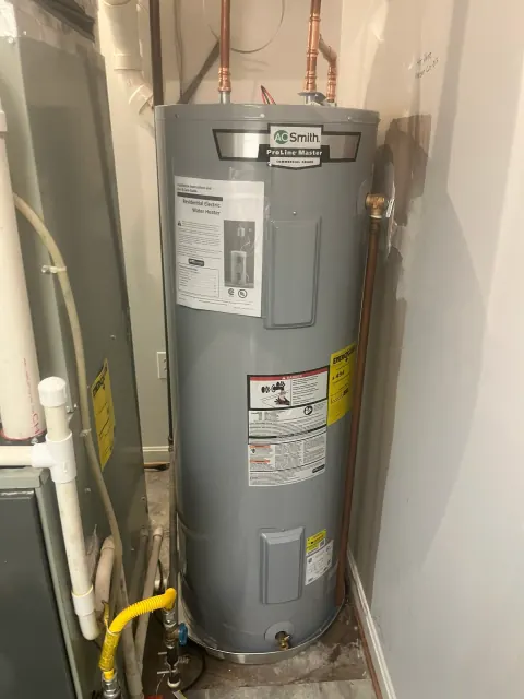 After: New A. O. Smith ProLine Master electric water heater in the same spot beside the furnace