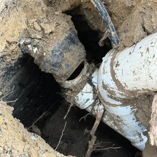 Before: Broken cast iron sewer pipe exposed in the hole at the cleanout.