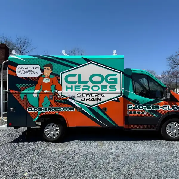 Wrapped Clog Heroes utility-body truck in full side profile on a gravel lot.