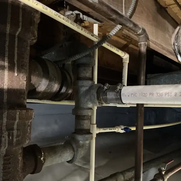 Before: Crawlspace tub drain line run without proper slope.