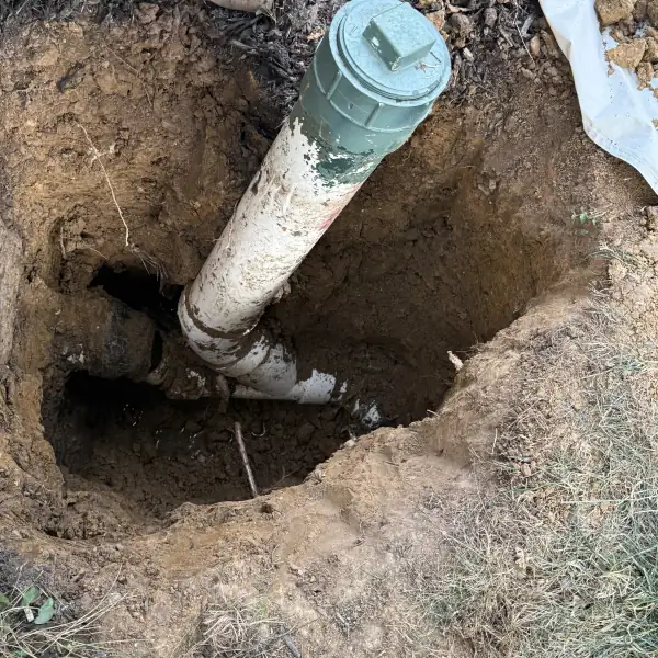 After: New sewer cleanout riser in the hole, ready for backfill.