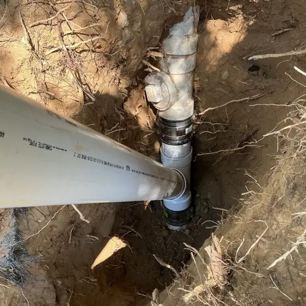 After: Repaired sewer line with new PVC and couplings in the excavation.