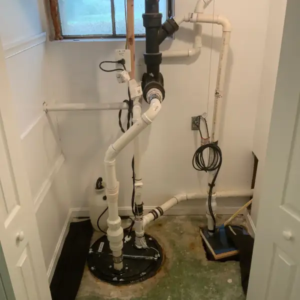 Finished sump and ejector pump installation with new PVC and check valves.