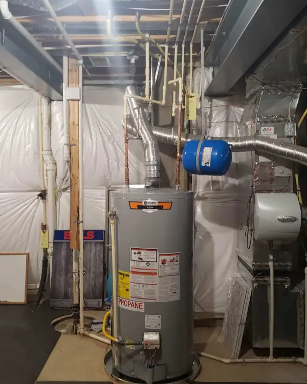 Propane water heater installed in an unfinished basement with new venting.