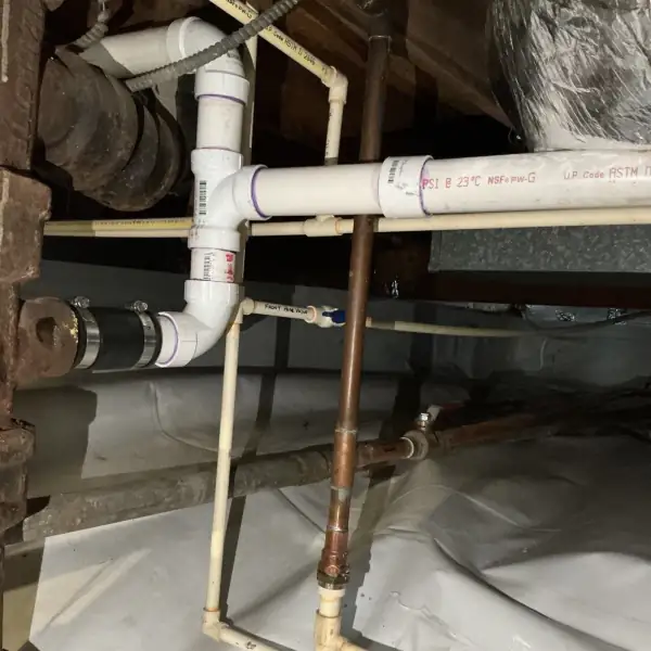 After: Crawlspace tub drain line rebuilt in PVC with proper slope.