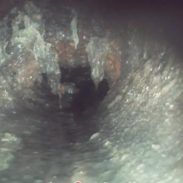 Sewer camera view of a collapsed section of sewer pipe.