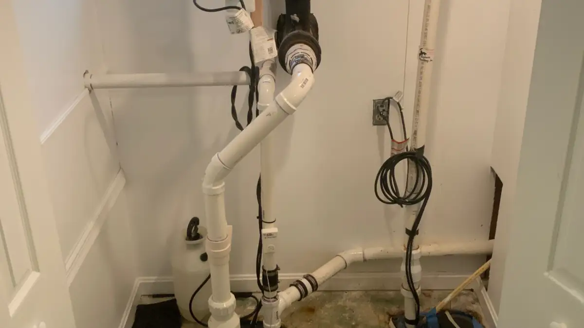 Finished sump and ejector pump installation with new PVC and check valves.