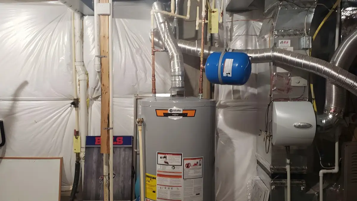 Propane water heater installed in an unfinished basement with new venting.