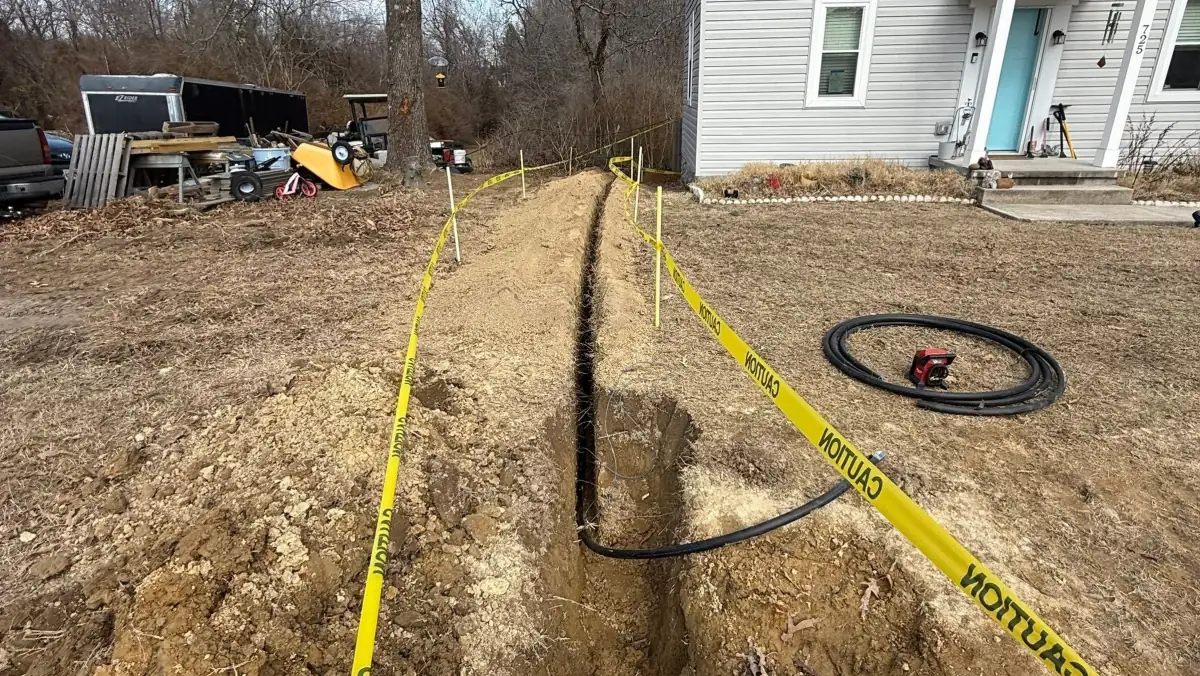 Water line trench marked off with caution tape.