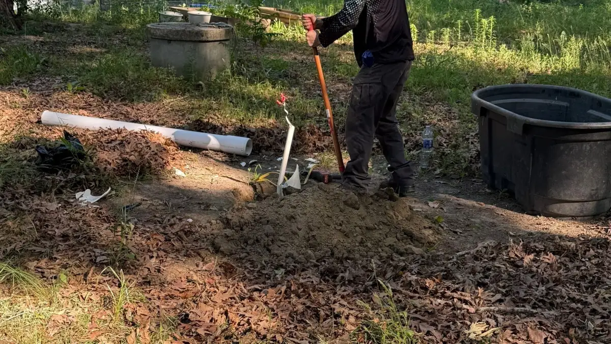 Technician repairing a well casing in the yard.