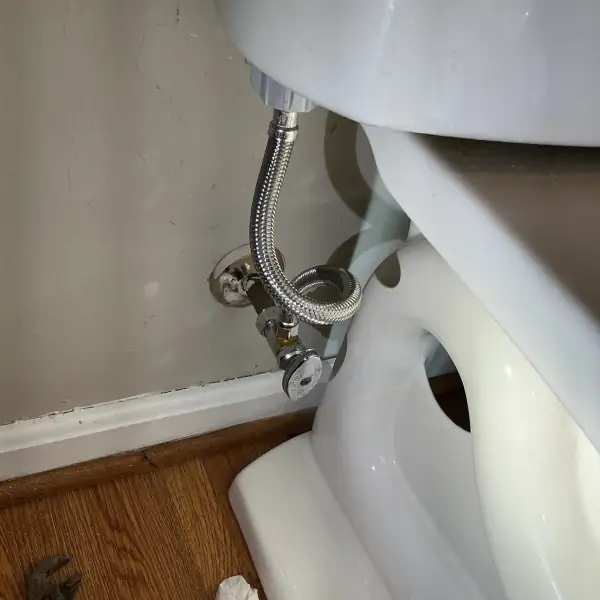 After: New braided toilet supply line and valve installed.